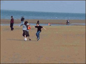 Omaha beach - mother and son playing soccer
