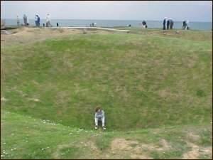 my daughter in one of the craters at Point-Du-Hoc